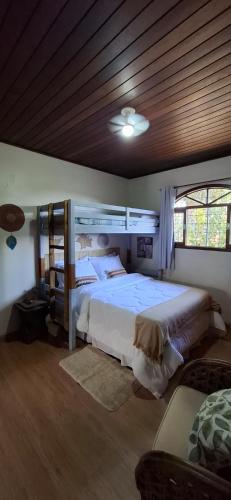 a bedroom with two beds and a wooden ceiling at Mini House Park in Campo Alegre