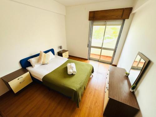 a small bedroom with a bed and a mirror at Faro Family Apartment in Faro
