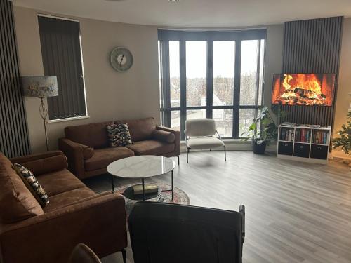 a living room with two couches and a tv at London Heathrow Apartment - West Drayton in Yiewsley