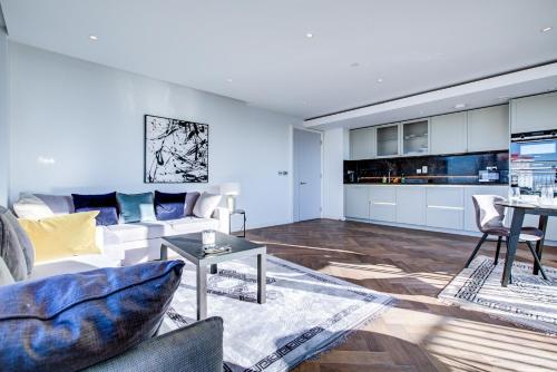 a living room with a couch and a table at Mayfair Skyline Residence in London