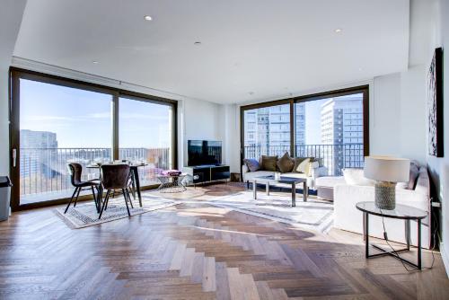 a living room with a couch and a table at Mayfair Skyline Residence in London