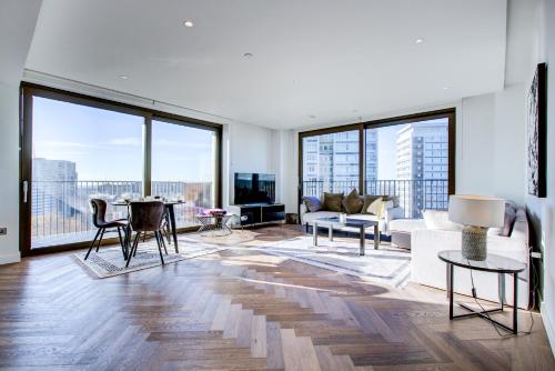 a living room with floor to ceiling windows at Mayfair Skyline Residence in London