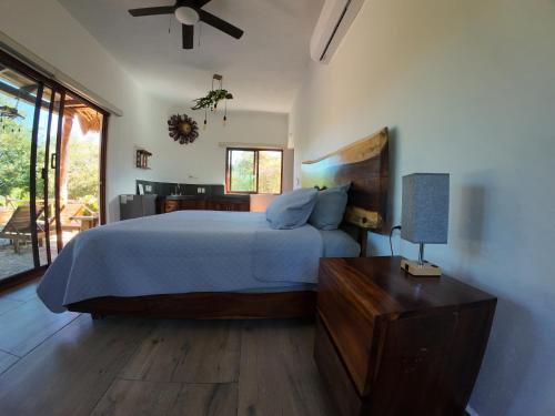 a bedroom with a bed and a table with a lamp at Hotel Aldea Maya in Valladolid