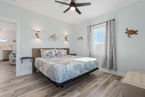 a bedroom with a bed and a ceiling fan at Salty waves 2 in Flagler Beach