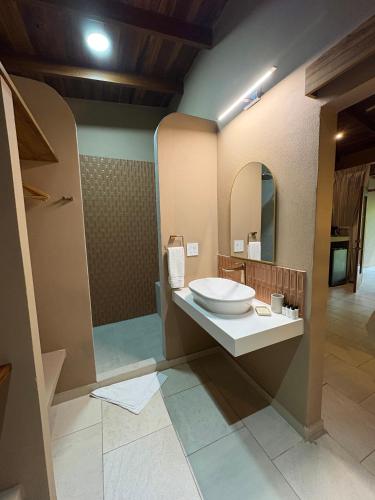 a bathroom with a sink and a mirror at The Falls by Lalibela in Manuel Antonio