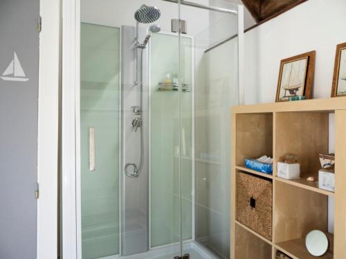 a shower with a glass door in a bathroom at D'une maison à l'autre in Cépie