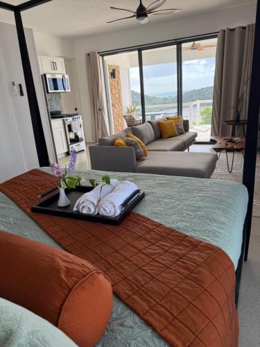 a living room with two beds and a couch at Egret at Galley Bay View in Five Islands Village
