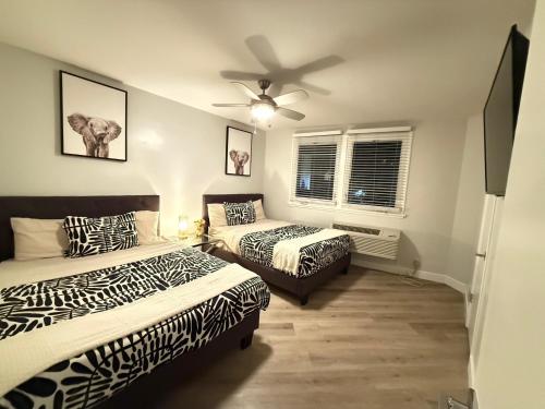 a bedroom with two beds and a ceiling fan at Hollywood Blvd Prime Location Walk to Attractions with Pool and Free Parking in Los Angeles