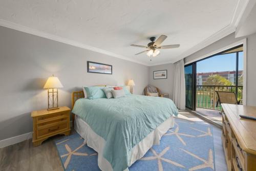 a bedroom with a bed and a large window at Pointe Santo B25 in Sanibel