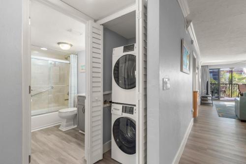 a bathroom with a washer and dryer in a house at Pointe Santo B25 in Sanibel