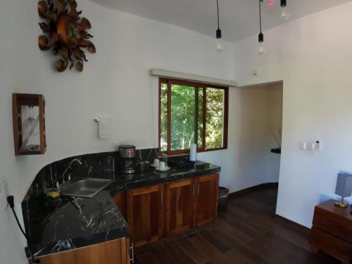 a kitchen with a sink and a counter top at Hotel Aldea Maya in Valladolid