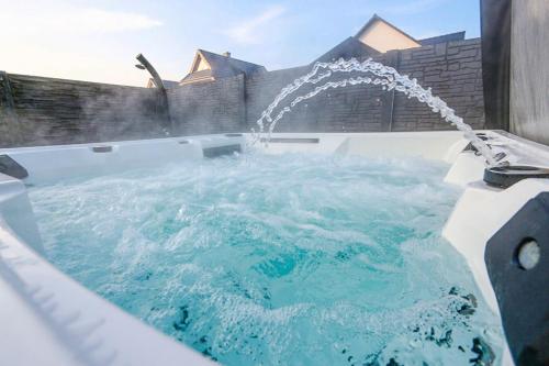 a hot tub with a water fountain at Ferienhaus Poolaris in Pruchten