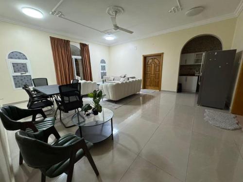 a living room with a couch and a table and chairs at doge villa 3 in Dubai