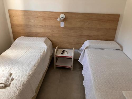 deux lits côte à côte dans une pièce dans l'établissement Valle De Las Sierras Hotel, à La Falda