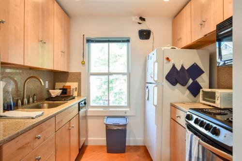 a kitchen with a white refrigerator and a window at Community beach and sundeck in Provincetown