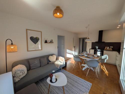a living room with a couch and a table at die Übernachterei - 3 hochwertige Premium-Appartements in Hüfingen