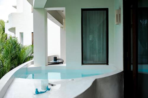 a bathroom with a sink and a mirror at Mak Nuk Village - Clothing Optional in Tulum