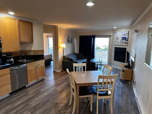 a kitchen and living room with a table and chairs at Inn at the Shore in Seaside