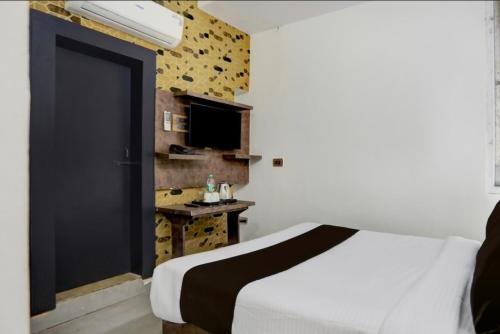 a bedroom with a white bed and a black door at hotel shad residency in Bankipur