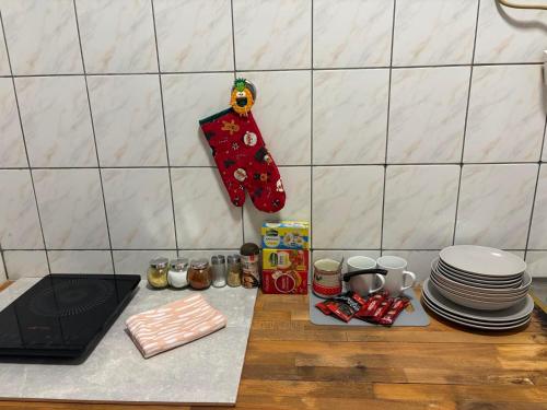 a kitchen counter with plates and a christmas stocking at Apartman Aleksandar 
