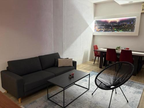 a living room with a couch and a table at Apartman Aleksandar 
