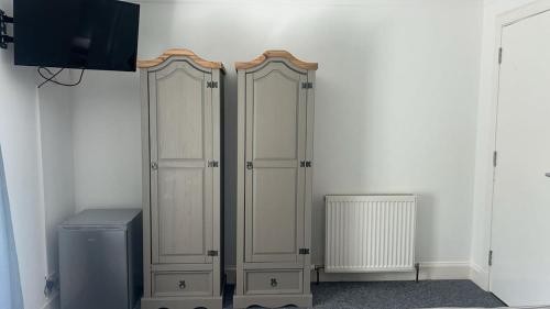 a room with two wooden cabinets and a refrigerator at Whole property in Kirkcaldy Fife in Fife