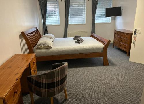 a bedroom with a bed and a table and a desk at Whole property in Kirkcaldy Fife in Fife