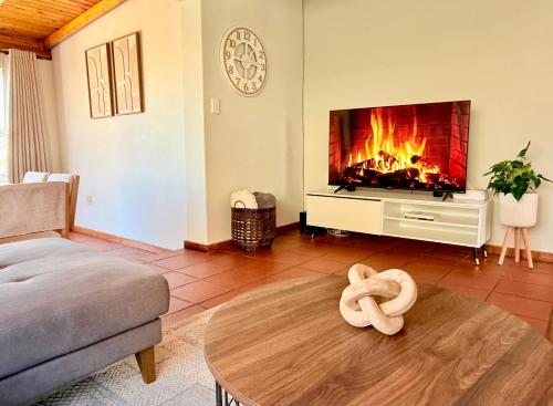 a living room with a fire in the fireplace at Bay Breeze in Eros Airport