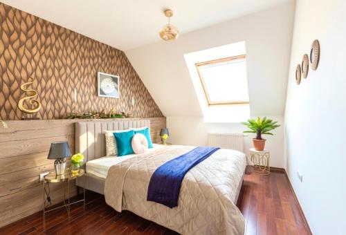 Velvet Sky Residence - InnerTown & Garage في بودابست: غرفة نوم بسرير كبير مع وسائد زرقاء