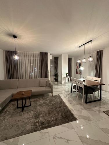 a living room with a couch and a table at Star apartmani in Novi Pazar