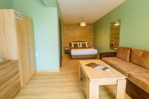 a living room with a couch and a bed at Jeweller Hotel in Ruse