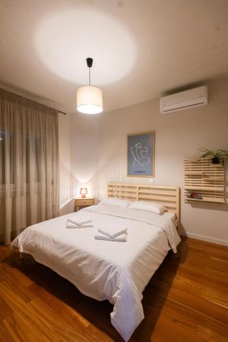 a bedroom with a large white bed in a room at Silyvo Cottage in Tríkala