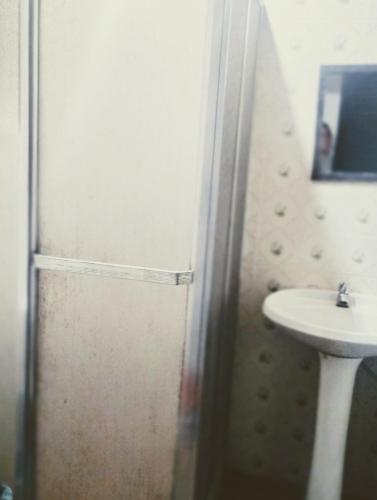 a bathroom with a shower and a sink at Casa Aloha Barra in Maricá