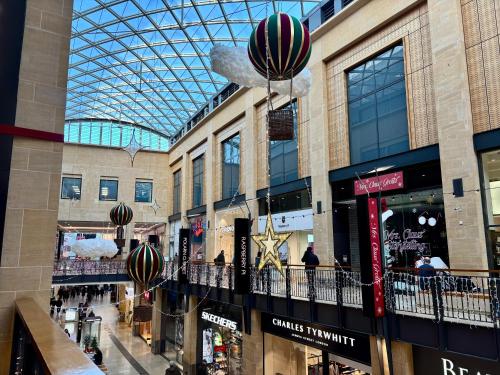 a shopping mall with a glass domed ceiling and balloons at Angel's (station accommodation) in Cambridge