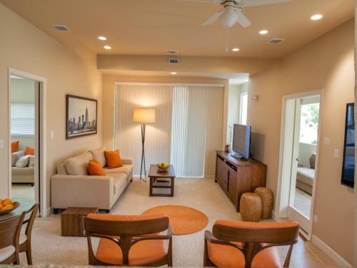 a living room with a couch and a tv at Modern Venice Beach Stay - Walk to Marina & Boardwalk in Los Angeles