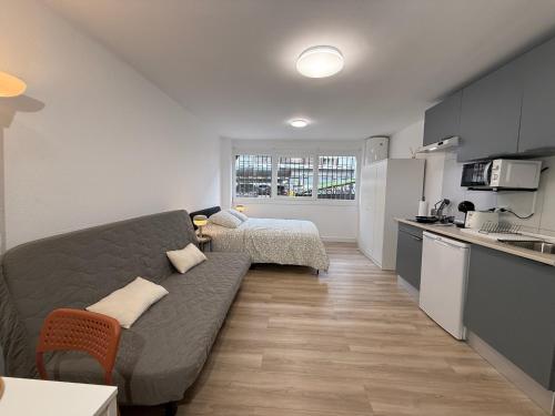 a living room with a couch and a kitchen at Estudios Areal in Vigo