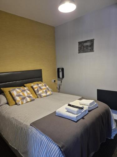 a bedroom with a bed with towels on it at Rooms at number 4 in North Walsham