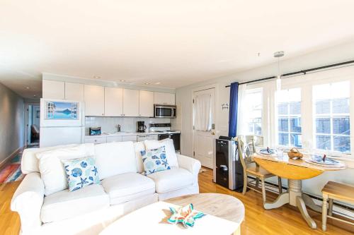 a living room with a white couch and a table at East End Condo Across from Assoc Beach in Provincetown