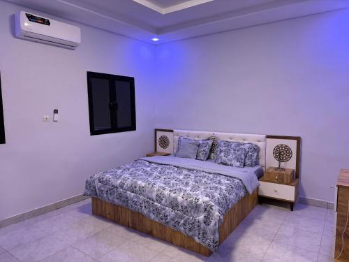 a bedroom with a bed in a white room at Modern Stay in Nouakchott