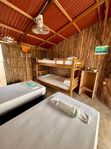 a room with two beds and a bunk bed at Hospedaje Palaaijat in Mayapo