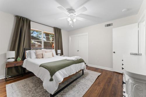 a bedroom with a bed and a ceiling fan at Rest & Play- Fire pit, Grill, PingPong- Walk 2 LSU in Baton Rouge