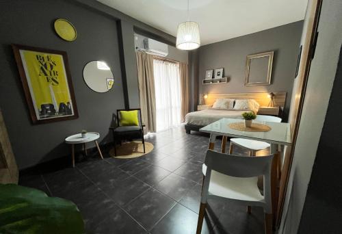 a bedroom with a bed and a table and chairs at Defensa 821 - Studios in San Telmo in Buenos Aires