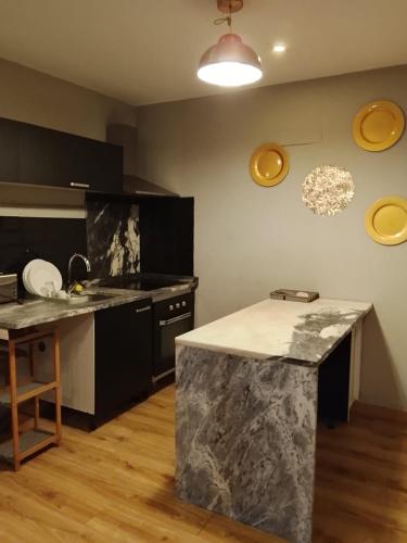 a kitchen with a marble counter top in a room at Porto Rio Douro apart in Valbom