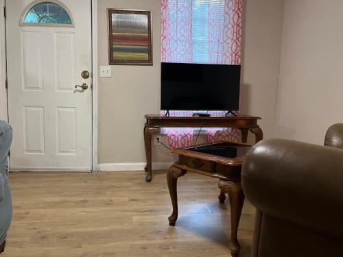 a living room with a desk with a computer on it at Cozy Efficiency Room WalktoUHS, near BU Guthrie in Johnson City