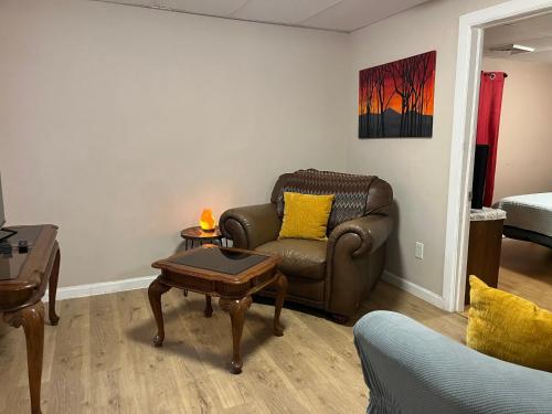 a living room with a couch and a table at Cozy Efficiency Room WalktoUHS, near BU Guthrie in Johnson City