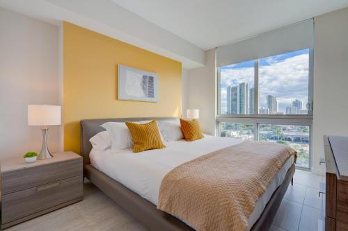 a bedroom with a large bed and a large window at 3900-902CH DESIGN DISTRICT, CONDO 2 BEDROOMS & 2 BATHROOMS in Miami