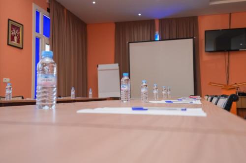 a table with bottles of water on top of it at Tanger Med Hotel, Conference & Catering in Ghdar Defla