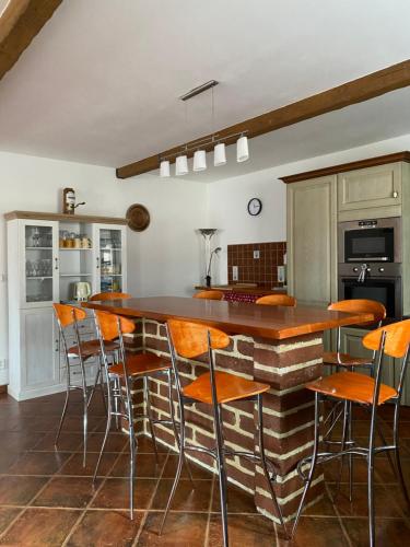 a kitchen with a bar with wooden stools at Chata u Špičáku in Albrechtice v Jizerských horách