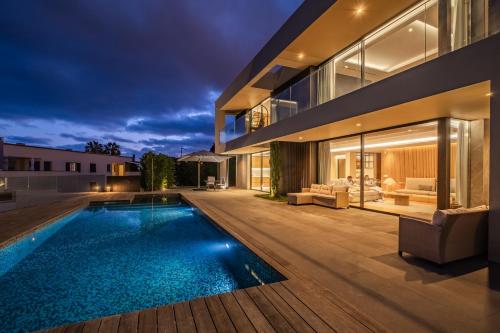 an exterior view of a house with a swimming pool at Villa Toscana by Madeira Dream Stays in Funchal