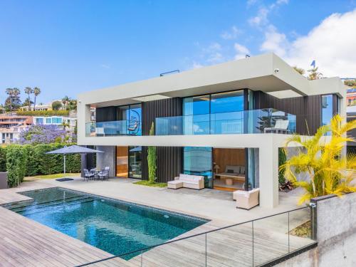 a house with a swimming pool in front of it at Villa Toscana by Madeira Dream Stays in Funchal